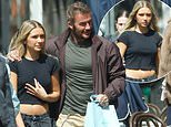 David Beckham drapes his arm around daughter Harper, 14, as she clutches £3,100 bag during NYC shopping trip