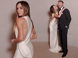 Victoria Beckham looks elegant in a silk white gown as she playfully poses with husband David ahead of the TIME100 Gala