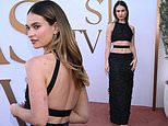 Lily James flashes a rare glimpse of her tattoos as she poses in a daring cutaway gown at a Disney event