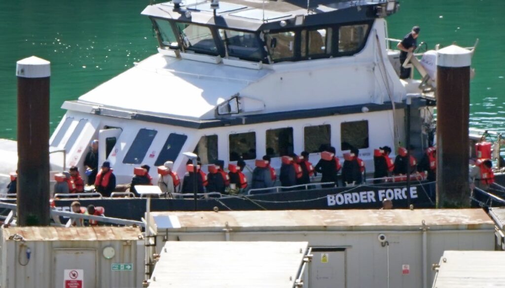 Nearly 400 migrants crossed English Channel in small boats on hottest day of year