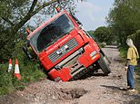 Lorry gets stuck after falling into massive sinkhole it had been sent to repair