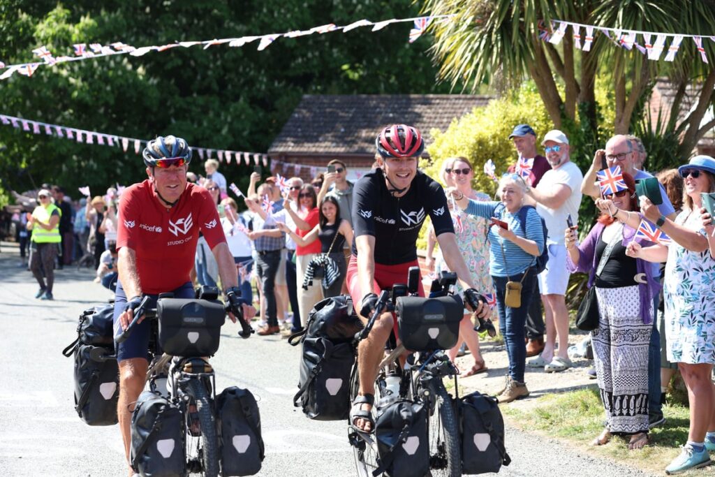 Father and son set three new world records after round-the-world charity cycle