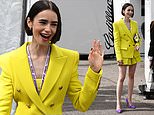 Lily Collins turns heads in a bold yellow shorts suit and killer heels as she struts around the F1 paddock ahead of the Monaco Grand Prix
