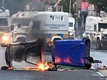 Makeshift barricade is set on fire near homes in Belfast on third night of riots over Sudanese migrant ‘knife attack’