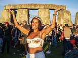 Thousands of sun-worshippers flock to Stonehenge to celebrate summer solstice as sun rises on longest day of the year