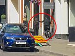 Moment thief on e-bike snatches phone from woman’s hands as she walks down central London pavement on a Sunday morning