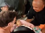 Astonishing moment newborn baby is pulled from earthquake rubble in Venezuela as death toll climbs with more than 51,000 still missing