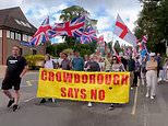 Protesters march in Crowborough to oppose decision to use former military site to house migrants until 2030