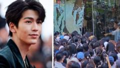 Watch: Fans break glass door trying to see TV star