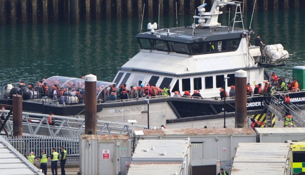 Teenager charged with piloting small boat to UK as over 640 migrants make trip in Burnham’s first week as PM