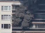 Several dead as inferno rips through apartment block in Belgium as residents seen scrambling on to roof to escape ‘raging fire’