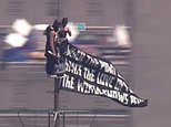 Daredevil couple scale Empire State Building and unfurl protest banner at very top before dramatic proposal