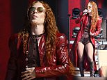 Jess Glynne seems to be feeling the heat as she bizarrely wears a leather trench coat, tights and knee high boots to perform at BST during the heatwave