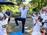 Prince Harry acts the goat as he attends children’s charity festival a day after Meghan and the children met Charles and Camilla