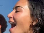 Kim Kardashian whoops with delight as boyfriend Lewis Hamilton shows off his impressive wakeboarding skills on lakeside break with her family
