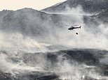 Wildfires continue to rage across UK as firefighters warn they could last for days – with temperatures still in heatwave conditions and set to get warmer tomorrow