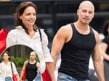 What a gentleman! Katie Holmes’ buff toyboy Jason Bard Yarmosky shows off his muscles as he carries her purse in NYC