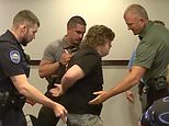 Midwest teacher, 37, is arrested for CLAPPING at public meeting about data centers