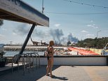 Ukrainian tourists sunbathe as Putin’s bombs rain down near Black Sea beach resort
