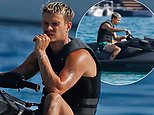 Romeo Beckham, 23, channels dad David’s noughties style with blond locks and displays his muscles on jet ski ride during family Ibiza trip