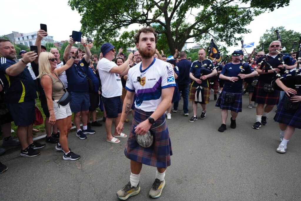 Tartan Army fan who raised £1m for charity in 3,000-mile US walk returns home