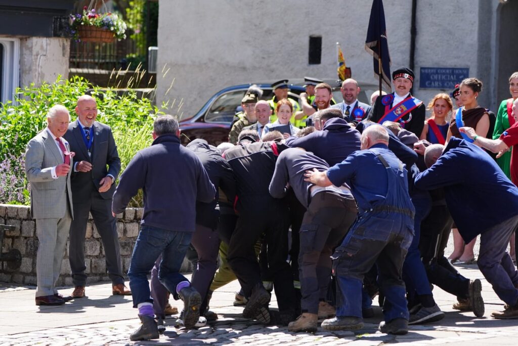 King starts ancient game in Jedburgh and steps back to watch scrum