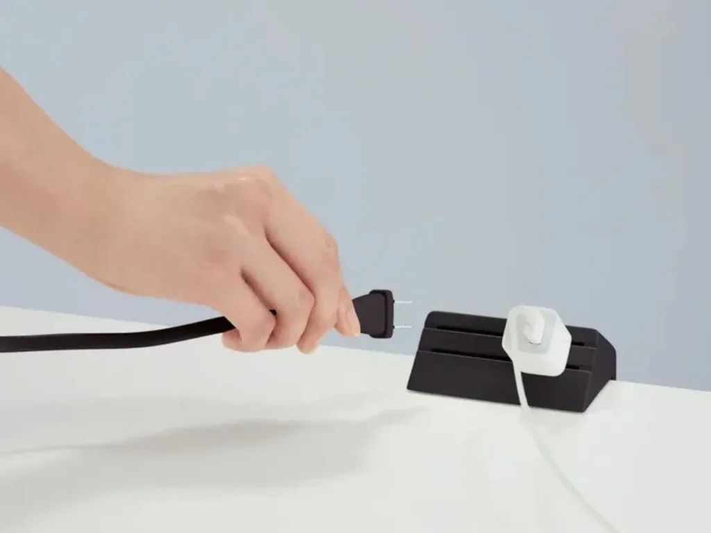 This sleek Japanese power strip finally fixes your office desk’s ugliest pain point